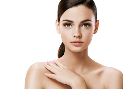 young woman with hand on clavicle